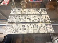 Full view of 21 black-and-white deckle-edge baseball cards laid out in sleeves