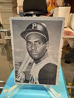Front view of Roberto Clemente photo card on stand