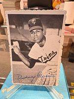 Front view of Rod Carew photo card showing image, facsimile signature, scalloped edges