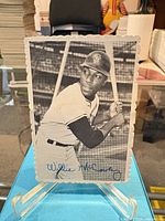 Front view of Willie McCovey signed photo card showing scalloped edges and blue ink signature