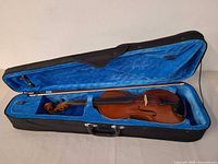 Violin in open hard case with bow visible