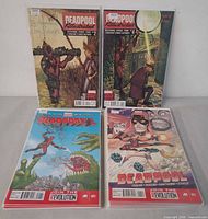 Four comics including Deadpool Killustrated #2 & #3 and two Deadpool #1 variant covers, showing bagged condition