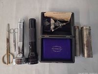 full kit laid out including flashlights, scissors, cylinders, case, burner
