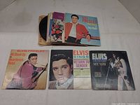 Stack of Elvis Presley 7" singles with three sleeves laid out: All Shook Up/Heartbreak Hotel, Return To Sender/Where Do You Come From, My Way