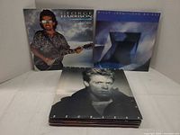 Stack fronted by George Harrison, Billy Joel, Bryan Adams albums