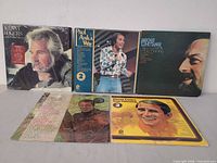 Group shot showing all five album covers