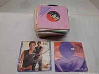 Stack of 7" singles with two picture sleeve examples