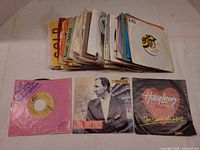 Stack of 7" singles with three picture sleeves in front