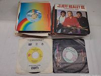 Stack of singles with Jeff Healey Band picture sleeve, other company sleeves visible