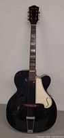 Full front view of Silvertone black archtop acoustic guitar