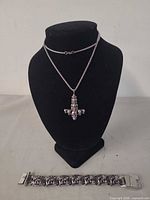Necklace on display stand and bracelet below, showing full set