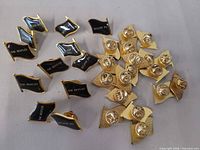 Group of approximately 30 Beatles flag lapel pins, fronts and backs visible