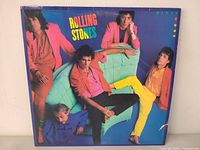 Front cover of Dirty Work LP showing band