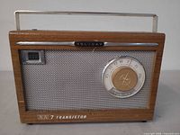 Front view showing Holiday branding, 7 transistor label, tuning dial, speaker grille