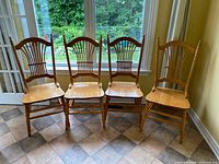 Front view of four matching sheaf-back chairs