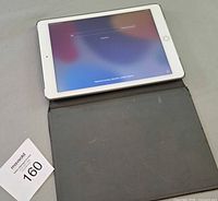 Front view of iPad Air 2 powered on with open folio case