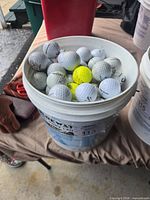 bucket filled with assorted golf balls