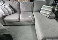 Full view of grey sectional with chaise and pillows