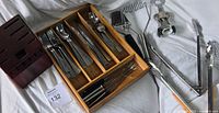 Overview showing knife block, wooden tray with flatware, tongs, corkscrew, and other utensils