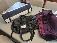 All three items: rolled beach mat, black Lululemon bag, burgundy Adidas bag