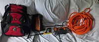 All items together: SwissGear backpack, Ridgid tool bag, FatMax saw, breaker bar, jigsaw, orange air hose