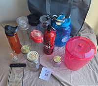 Group shot of all bottles, jars, pitcher and tote