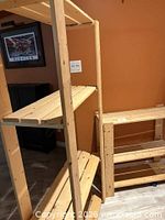Tall and half-height wooden shelving units with slatted shelves visible