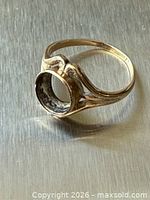 Ring angled side view showing empty bezel and split shoulders
