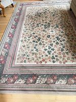 Full view of floral area rug on floor