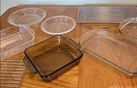 Overview of glass pans, pie plates and wire racks on table
