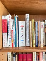 Top shelf showing self-help, spirituality and medical reference titles including Awakening the Buddha Within and The Pill Book