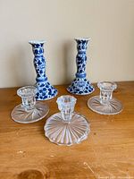 Five candlesticks arranged together showing overall lot