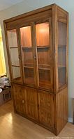 Front view showing entire cabinet with doors and interior light on