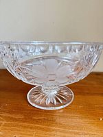 side view of cut crystal pedestal bowl showing floral cuts and pedestal foot
