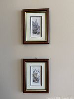 Pair of framed 3D decoupage prints on wall