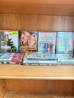 Overview of DVDs on shelf showing upright and stacked titles