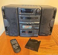 Front view of complete JVC stereo system with speakers, remote and CD magazine