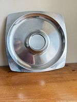 Front view square stainless steel tray with central recess