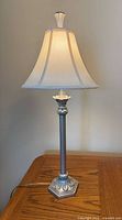 Full view of lamp on table, shade illuminated