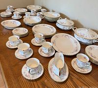 Full lot displayed on table showing plates, bowls, tureens, cups and saucers
