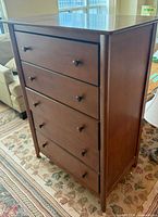 Full view of dark brown 5-drawer chest of drawers