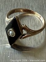 Ring angled view showing face design and 14K mark