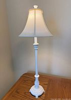 Full view of assembled white metal lamp with shade