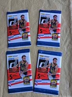 Four sealed Panini Donruss Basketball 2020-21 packs displayed