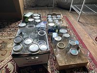 Boxes of assorted quart and pint mason jars with lids