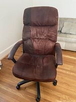 Front view of brown office chair showing overall design and upholstery
