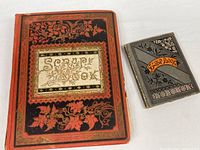 Front covers of both scrapbooks showing size difference and decorative designs