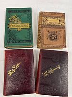 Four decorative hardcover books front covers visible