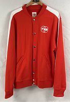 Full front view of red TWA jacket hanging