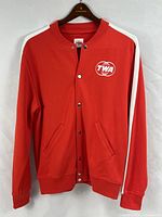 Front view of red TWA track jacket showing logo, stripes, full length